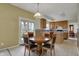 Dining area is conveniently connected to a kitchen featuring light wood cabinetry and stainless steel appliances at 11249 Tall Trees Dr, Fishers, IN 46038