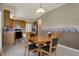 Dining area is conveniently connected to a kitchen with light wood cabinetry and stainless steel appliances at 11249 Tall Trees Dr, Fishers, IN 46038