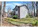This home's side view showcases tidy landscaping, mature trees, and a mix of brick and vinyl siding at 11249 Tall Trees Dr, Fishers, IN 46038