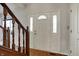 Inviting foyer with hardwood floors, featuring a staircase and a front door with sidelights at 11249 Tall Trees Dr, Fishers, IN 46038