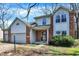 Charming two-story home with brick and siding, featuring an attached two-car garage and well-maintained landscaping at 11249 Tall Trees Dr, Fishers, IN 46038
