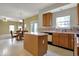 Bright eat-in kitchen features light wood cabinetry and a center island, ideal for casual dining and food preparation at 11249 Tall Trees Dr, Fishers, IN 46038