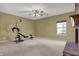 Spacious living room with beige walls, ceiling fan, and a fireplace, offering a cozy and inviting atmosphere at 11249 Tall Trees Dr, Fishers, IN 46038