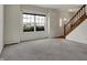 Bright living room with a large window and a staircase, offering a cozy and inviting atmosphere at 11249 Tall Trees Dr, Fishers, IN 46038