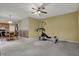 Open-concept living area includes a dining space and kitchen with light wood cabinetry and black appliances at 11249 Tall Trees Dr, Fishers, IN 46038