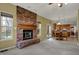Cozy living room boasts a brick fireplace and provides access to the dining area and kitchen with light wood accents at 11249 Tall Trees Dr, Fishers, IN 46038