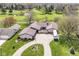 Aerial view of a charming single-story home with an expansive lawn and scenic golf course views at 1153 Diablo Rd, Greenwood, IN 46143