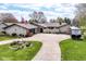 Charming single-story home with manicured lawn, circular driveway, and American flag at 1153 Diablo Rd, Greenwood, IN 46143