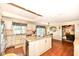 A bright kitchen featuring an island with granite countertops, stainless steel appliances, and hardwood floors at 1153 Diablo Rd, Greenwood, IN 46143