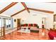 Bright living room with hardwood floors, vaulted ceiling with wood beams, and a walkout to screened room at 1153 Diablo Rd, Greenwood, IN 46143