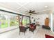 Bright and airy sunroom with ample seating, large windows, and views of the lush backyard at 1153 Diablo Rd, Greenwood, IN 46143