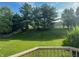 A well manicured lawn, mature trees, and a fence complete this backyard oasis at 12332 Cobblefield Ct, Fishers, IN 46037