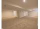 Open basement with neutral carpeting, a door, and neutral walls, offering flexible space at 12332 Cobblefield Ct, Fishers, IN 46037