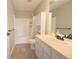 Bathroom with a shower-tub combo, vanity with sink, and a large mirror at 12332 Cobblefield Ct, Fishers, IN 46037