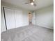 Bedroom featuring large closet space, neutral carpeting, and a ceiling fan for comfort at 12332 Cobblefield Ct, Fishers, IN 46037