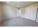Well-lit bedroom with neutral carpeting, closet, and an open doorway at 12332 Cobblefield Ct, Fishers, IN 46037