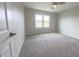 Bright bedroom featuring a ceiling fan, window, and neutral carpeting at 12332 Cobblefield Ct, Fishers, IN 46037