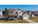 Charming two-story home with a brick and siding exterior, attached garage, and manicured lawn at 12332 Cobblefield Ct, Fishers, IN 46037