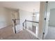 Second-floor hallway features neutral carpet and white banisters with access to multiple rooms at 12332 Cobblefield Ct, Fishers, IN 46037