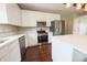 Modern kitchen featuring white cabinets, stainless steel appliances, and quartz countertops at 12332 Cobblefield Ct, Fishers, IN 46037