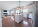 Open concept kitchen with an island, stainless appliances, and hardwood flooring at 12332 Cobblefield Ct, Fishers, IN 46037