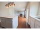 View of the kitchen island, sink, and cabinets, with an open view to the dining and living room at 12332 Cobblefield Ct, Fishers, IN 46037