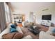Bright open-concept living room featuring hardwood floors, comfortable seating, and great natural light at 12332 Cobblefield Ct, Fishers, IN 46037