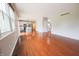 Living room with hardwood floors, ample natural light, and an open view of the kitchen and staircase at 12332 Cobblefield Ct, Fishers, IN 46037