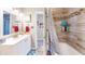 Bright bathroom featuring a tub with tiled shower, and a white vanity sink at 126 Windemere Rd, Whiteland, IN 46184