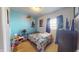Cozy bedroom with single bed, bright accent wall, and vibrant cartoon themed bedding at 126 Windemere Rd, Whiteland, IN 46184
