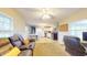 Inviting living space with a comfortable recliner and open access to the eat-in kitchen at 126 Windemere Rd, Whiteland, IN 46184