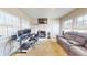 Bright living room featuring a fireplace, large windows, and a dedicated workspace at 126 Windemere Rd, Whiteland, IN 46184