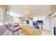 Open concept living area with a cozy sofa, adjacent to a kitchen with white cabinets at 126 Windemere Rd, Whiteland, IN 46184