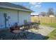 Outdoor patio area with metal table, chairs, and fenced yard at 126 Windemere Rd, Whiteland, IN 46184