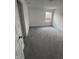 A bright bedroom with gray carpeting features a window allowing in ample natural light at 1272 Southlake E Ave, Greenwood, IN 46143