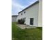 Exterior of home with white siding, concrete patio, and sliding glass doors to backyard at 1272 Southlake E Ave, Greenwood, IN 46143