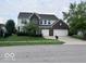 Traditional two-story home featuring a brick facade, attached two-car garage and well-manicured lawn at 1272 Southlake E Ave, Greenwood, IN 46143