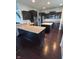 Kitchen with dark cabinets, granite countertops, stainless steel appliances, and hardwood floors at 1272 Southlake E Ave, Greenwood, IN 46143