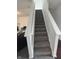 Carpeted stairs with white railings leading to the upper level of the home at 1272 Southlake E Ave, Greenwood, IN 46143