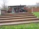 Multi-tiered wooden deck leading to a brick home with an outdoor dining area at 13065 Allman Dr, Mooresville, IN 46158