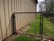 Backyard with black chain link fence dividing the yard from the open field beyond at 13065 Allman Dr, Mooresville, IN 46158
