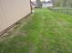 Side yard, featuring grass, metal building and the chain link fence in background at 13065 Allman Dr, Mooresville, IN 46158