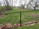 Fenced backyard view, with grassy area, chain link fence and wooded area in background at 13065 Allman Dr, Mooresville, IN 46158