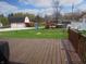 Spacious backyard with deck offering a view of a barn, playground, and above ground pool at 13065 Allman Dr, Mooresville, IN 46158