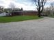 Expansive backyard featuring a classic brick house, lush greenery, and a well-maintained deck at 13065 Allman Dr, Mooresville, IN 46158