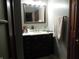 Neutral-toned bathroom with dark wood vanity, white counter top, and decorative towel at 13065 Allman Dr, Mooresville, IN 46158