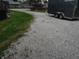 Gravel driveway with ample space for parking, leading to the property's entrance at 13065 Allman Dr, Mooresville, IN 46158