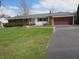Charming single-story home with a well-kept lawn and an attached two-car garage and paved driveway at 13065 Allman Dr, Mooresville, IN 46158