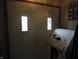 A welcoming double door entrance with small windows and a playhouse nearby at 13065 Allman Dr, Mooresville, IN 46158