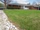 Well-maintained lawn and landscaped area in front of a single-story home with white and brick exterior at 13065 Allman Dr, Mooresville, IN 46158